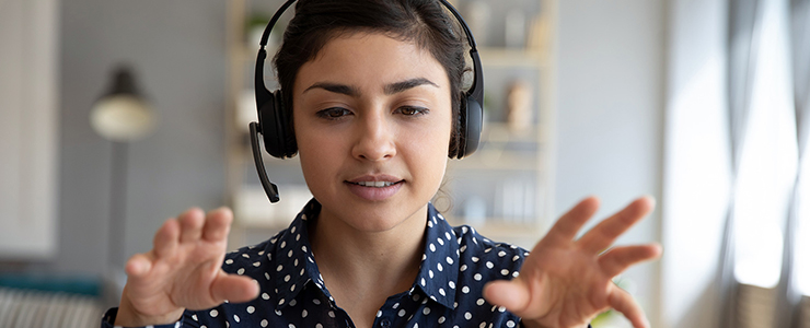 Woman wearing a headset talking with her hands
