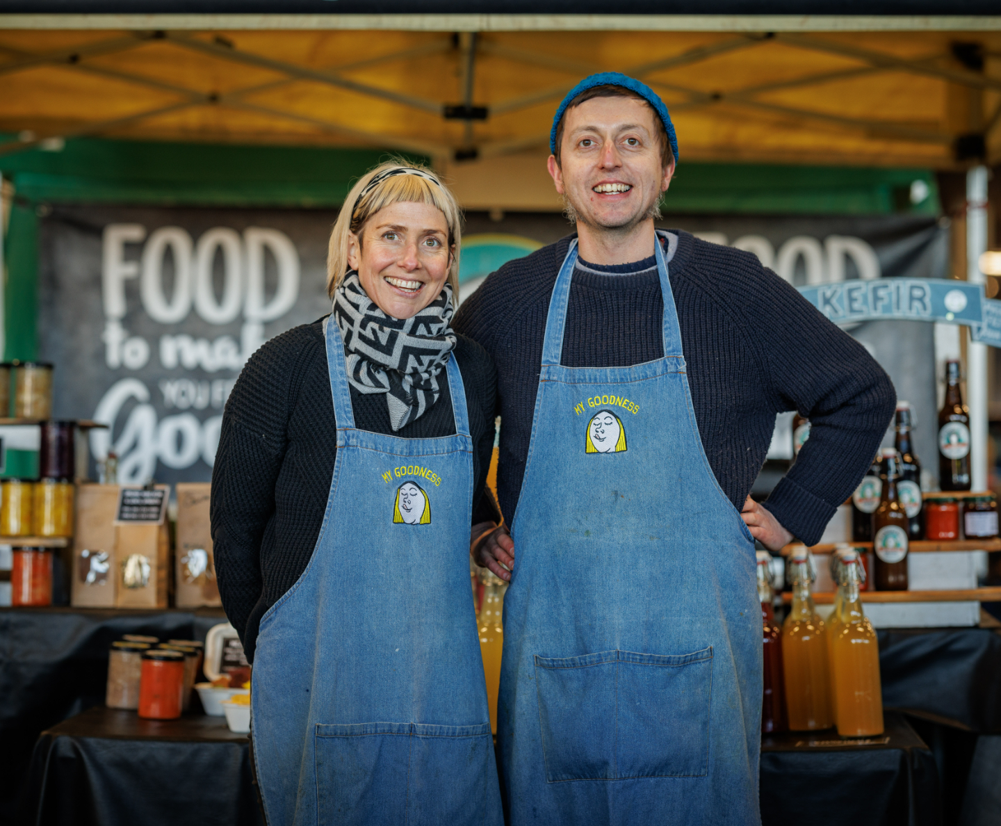 Two venders in aprons at mahon point farmers market