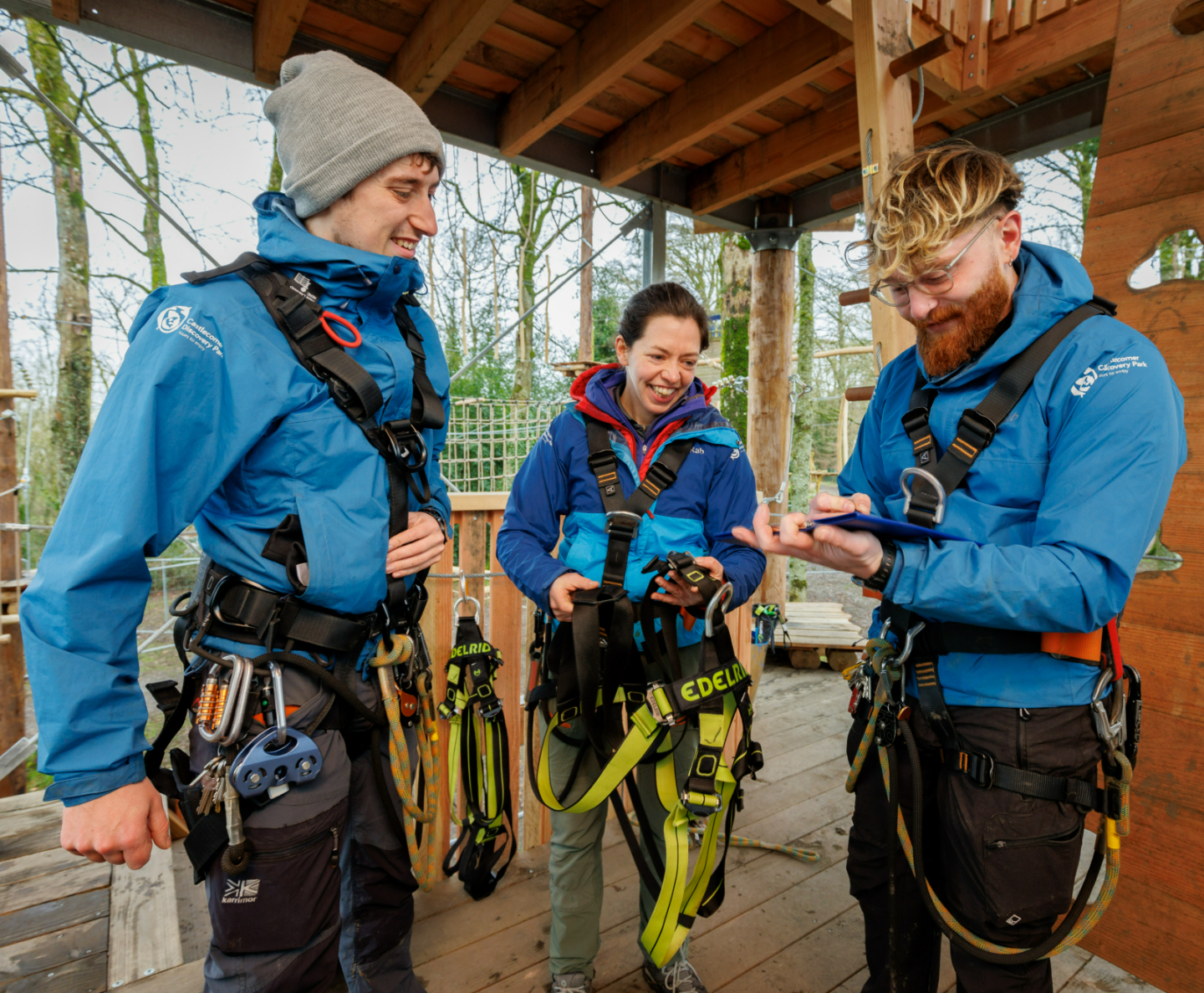 Three people with climbing gear