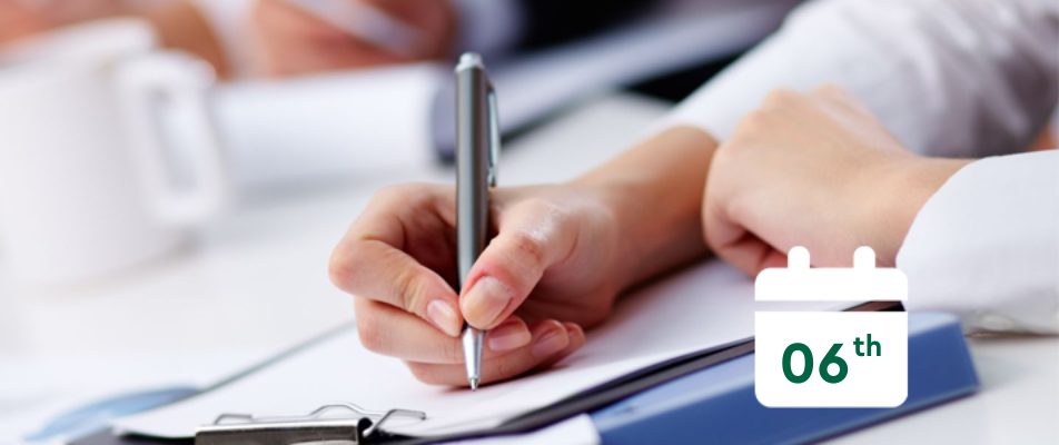 Person using a pen to write in a note book with a calendar that says 6th