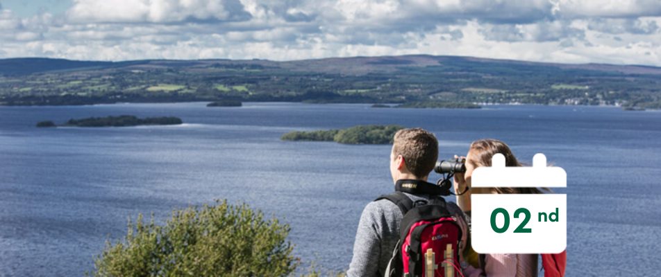 A couple look at the horizon from a mountain and a calendar that says 2nd