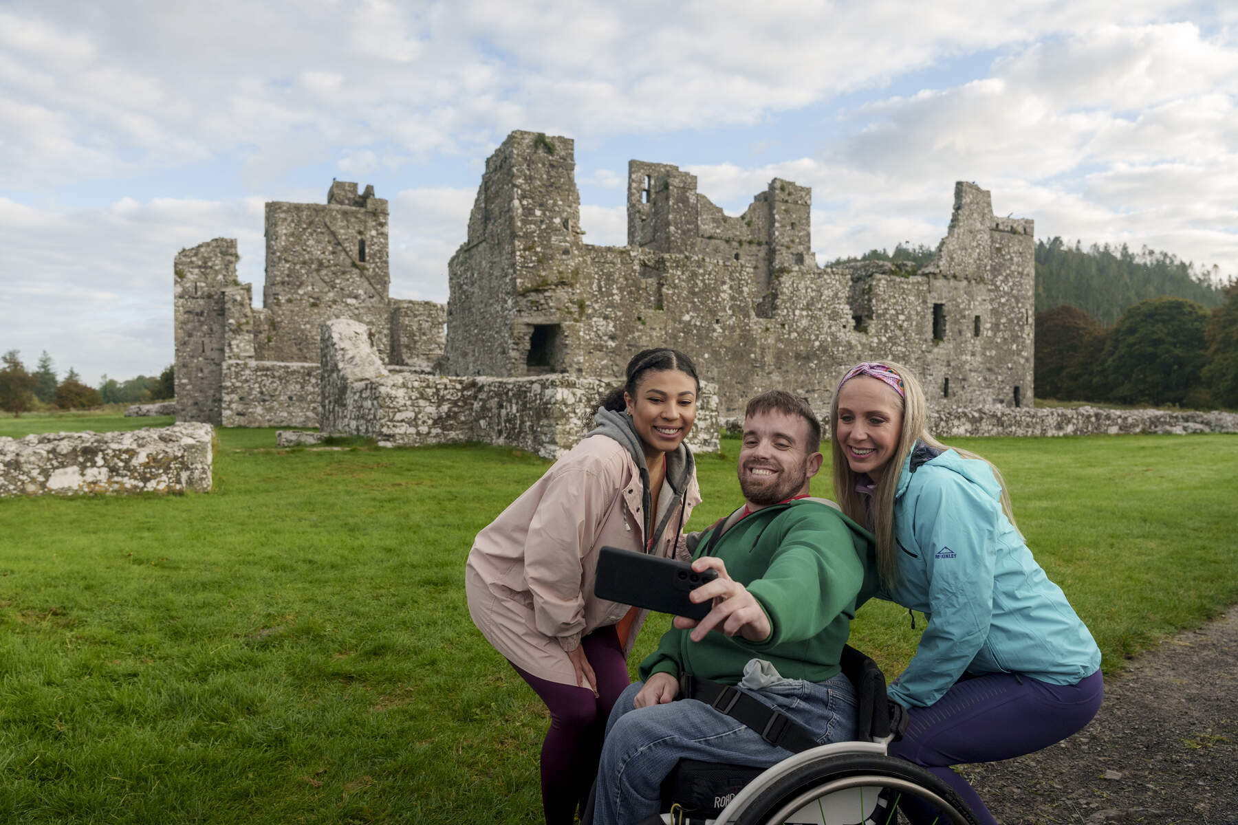 Three people taking a selfie outside of Fore Abbey