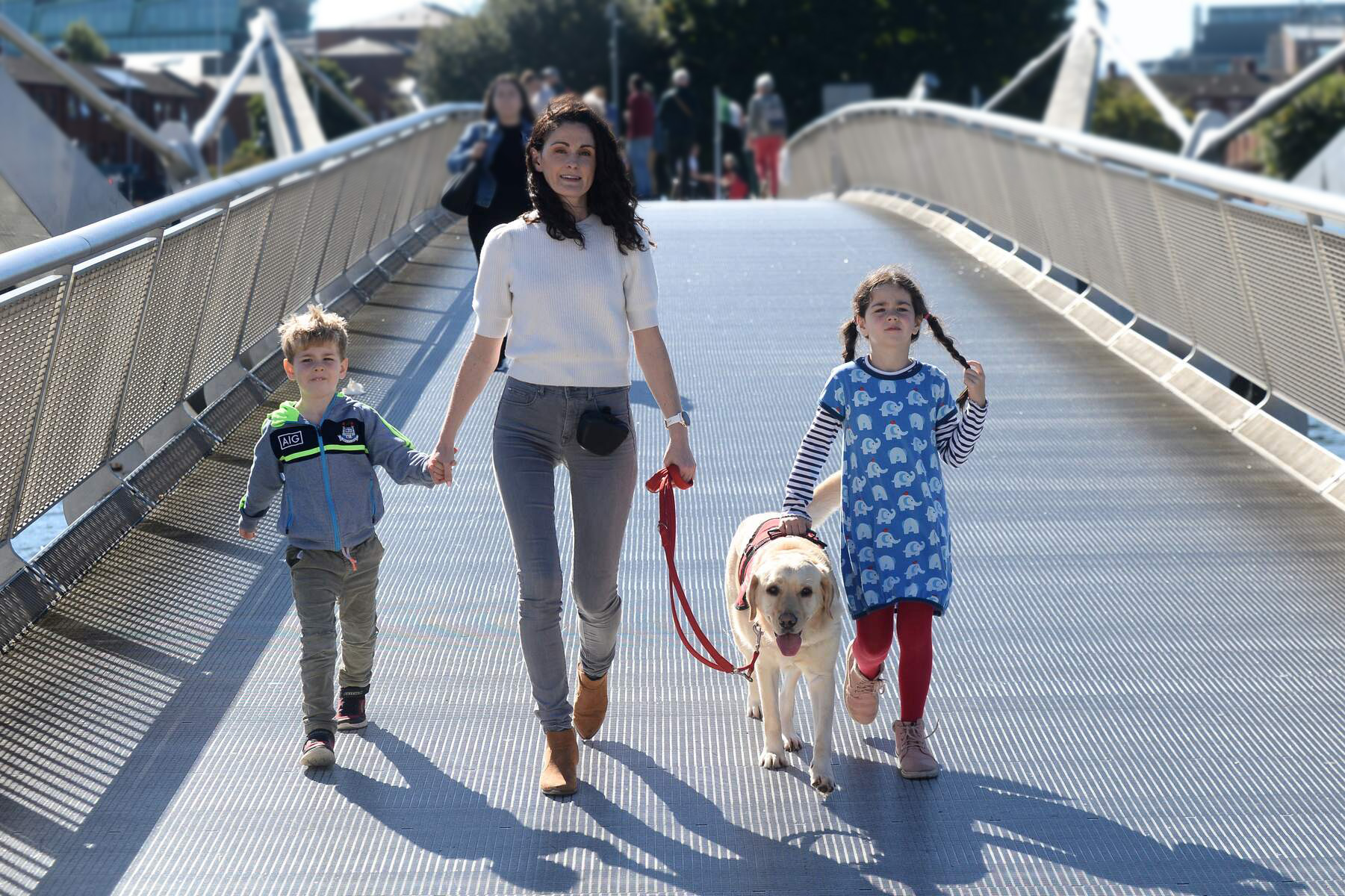 Family walking across a bridge in Dublin City Centre