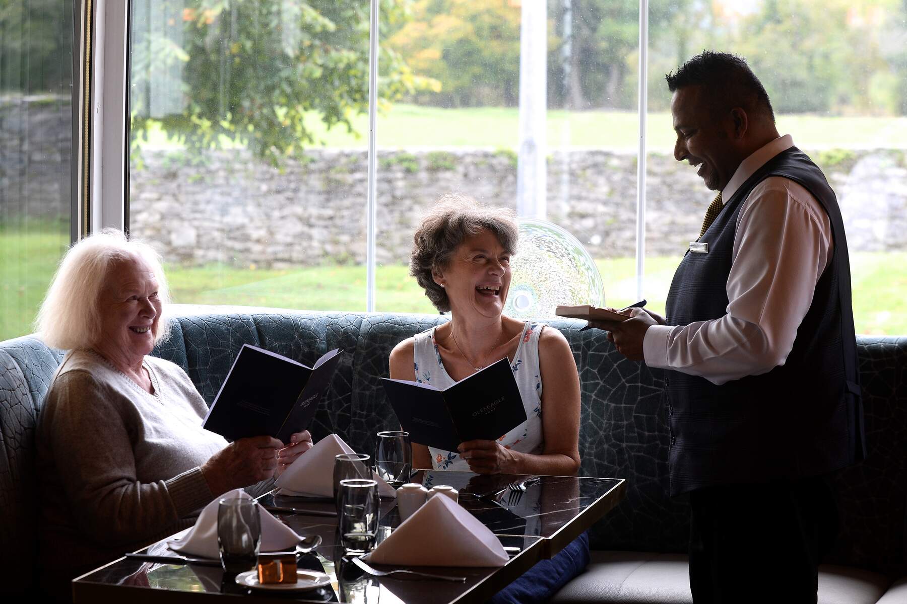 two women ordering food in a hotel