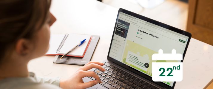 Woman using laptop, calendar icon reads 22nd