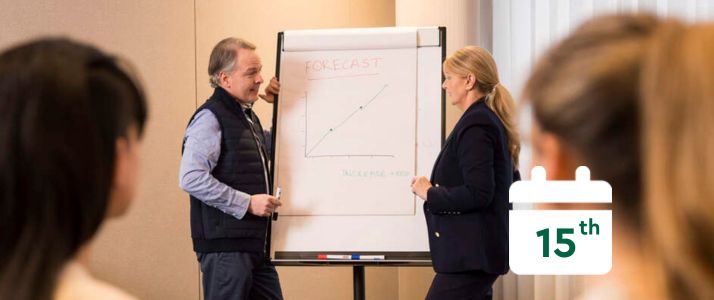 Colleagues looking at a graph, calendar icon reads 15th