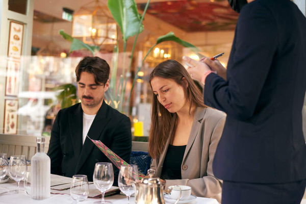 Man and woman at restaurant table.