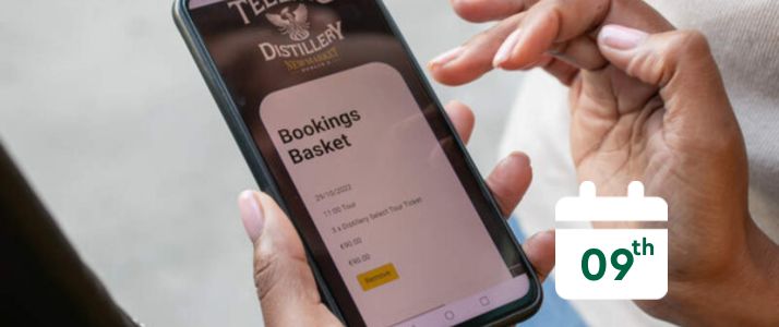 Person using phone to make an online booking, calendar icon reads 9th