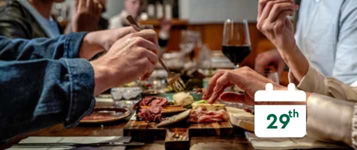 People sitting around a table eating, calendar icon reads 29th
