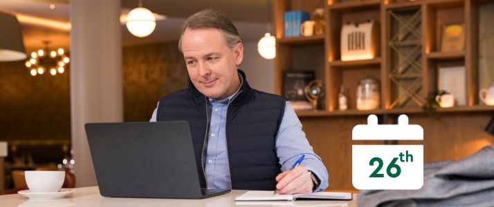 Man using laptop, calendar icon reads 26th